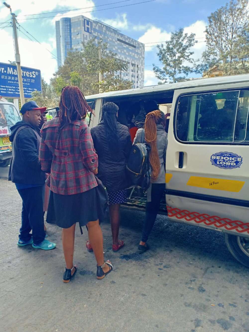 passengers boarding a Nissan in Nairobi